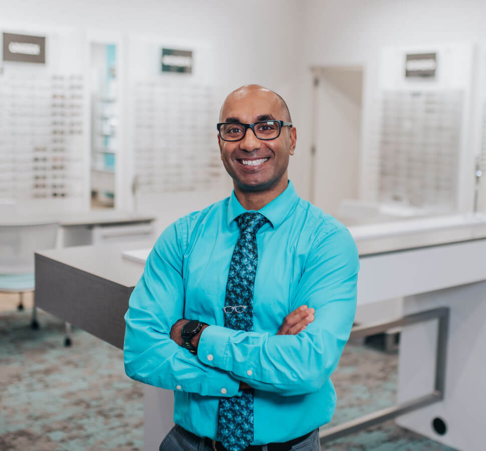 Dr. Nick Lillie standing in front of glasses selection